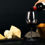 Enjoy a fine dining experience with red wine and gourmet cheese displayed elegantly.